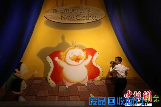 小朋友在安徒生童话进入中国百年纪念展上与展出的作品互动。　泱波　摄