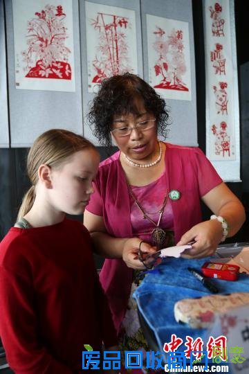 （资料图）2013年7月21日，齐秀花随山东省民间文化代表团访问冰岛向当地民众展示山东传统绝活剪纸艺术。 邱江波摄