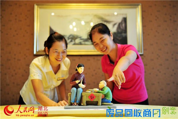 市民在观赏湖北省宜昌市夷陵区民间艺人艾民制作的面塑作品“妈妈菜的味道”