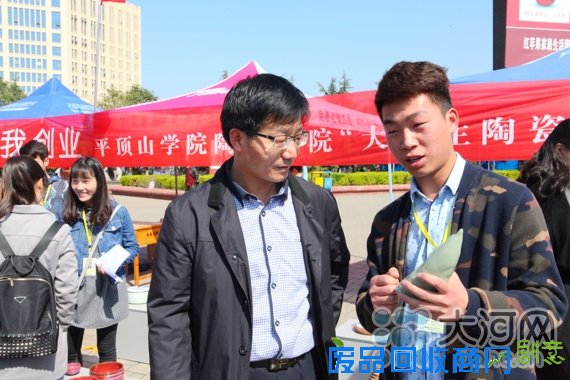平顶山学院陶瓷专业学生在“陶瓷创业集市”上向市民介绍作品